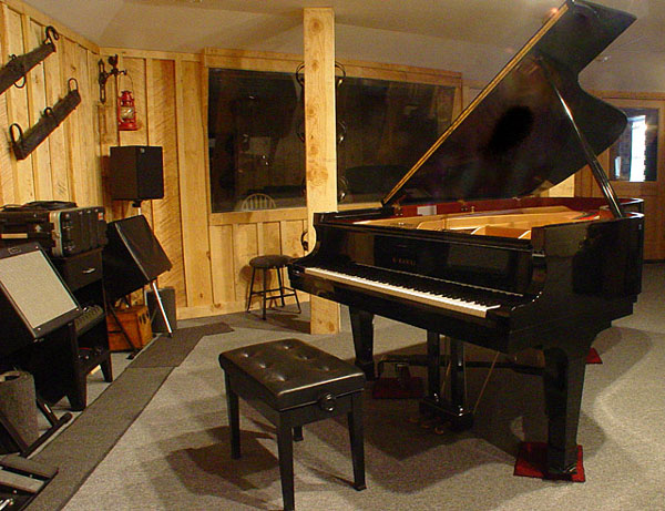 Piano in the foreground, drum isolation booth in the background